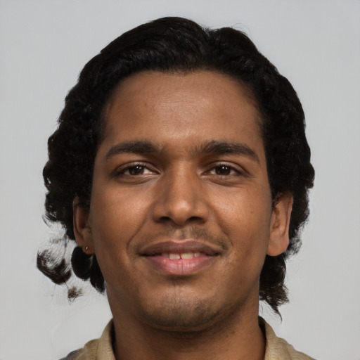 Joyful black young-adult male with short  black hair and brown eyes