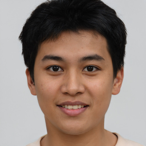 Joyful asian young-adult male with short  brown hair and brown eyes