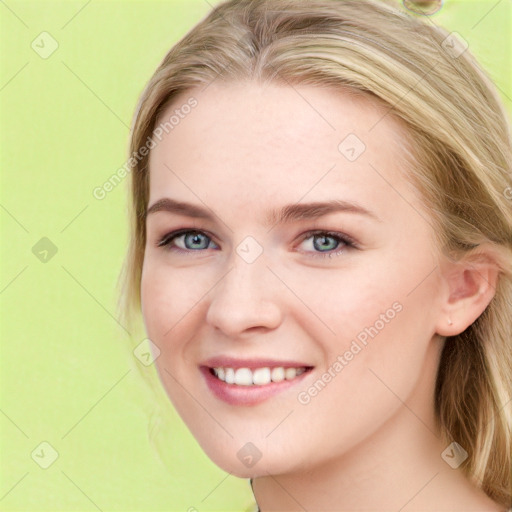 Joyful white young-adult female with long  brown hair and blue eyes