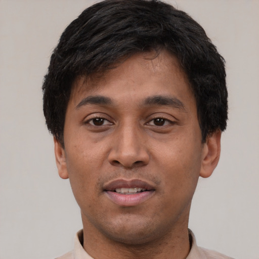 Joyful asian young-adult male with short  black hair and brown eyes