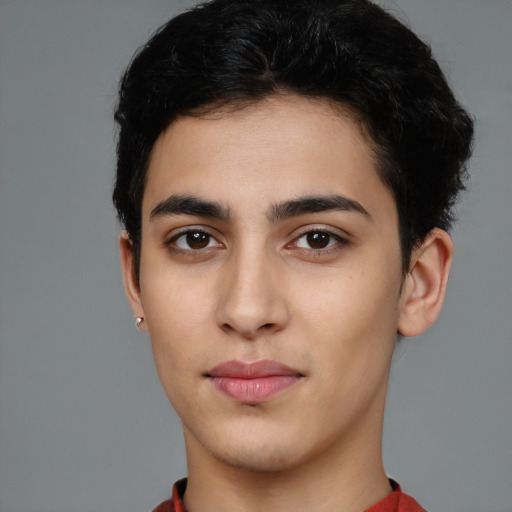 Joyful white young-adult male with short  black hair and brown eyes