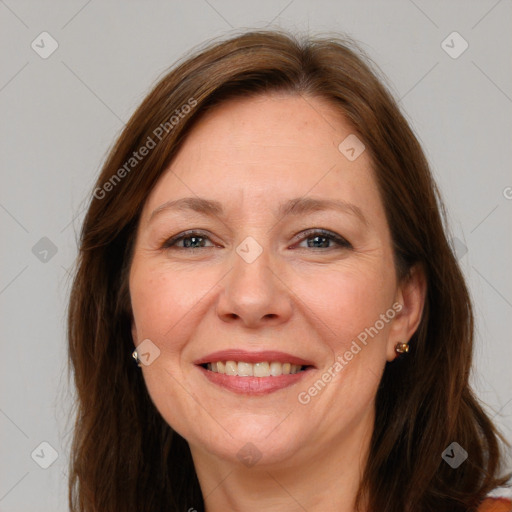 Joyful white adult female with long  brown hair and brown eyes