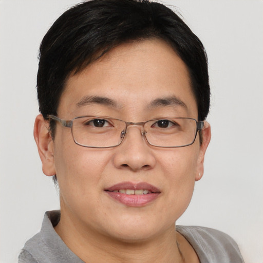 Joyful asian adult female with short  brown hair and brown eyes