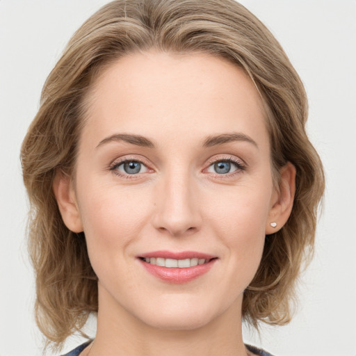 Joyful white young-adult female with medium  brown hair and blue eyes