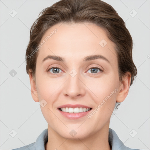 Joyful white young-adult female with short  brown hair and grey eyes