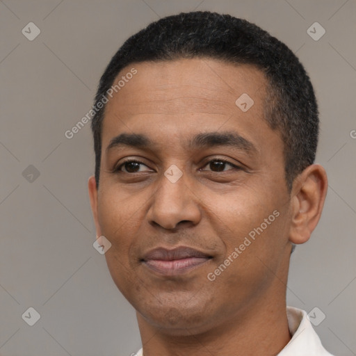 Joyful latino adult male with short  black hair and brown eyes