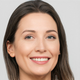 Joyful white young-adult female with long  brown hair and brown eyes