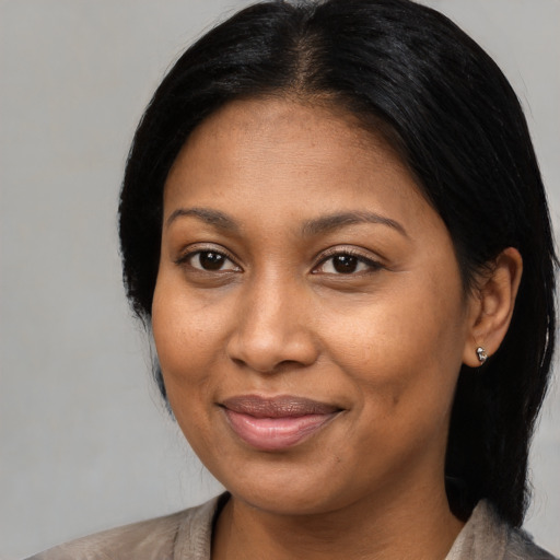Joyful asian adult female with medium  black hair and brown eyes