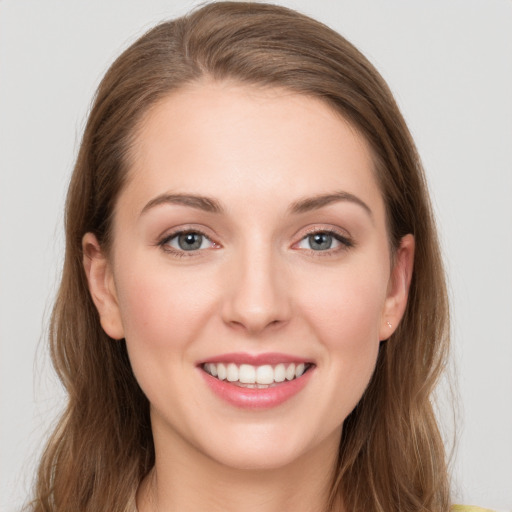 Joyful white young-adult female with long  brown hair and grey eyes