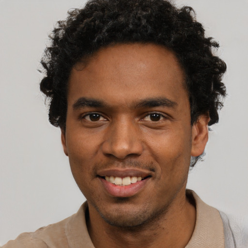 Joyful black young-adult male with short  black hair and brown eyes