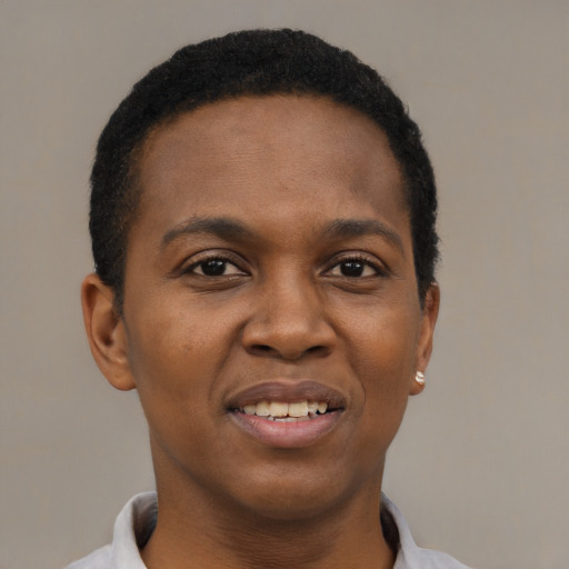 Joyful black young-adult female with short  black hair and brown eyes
