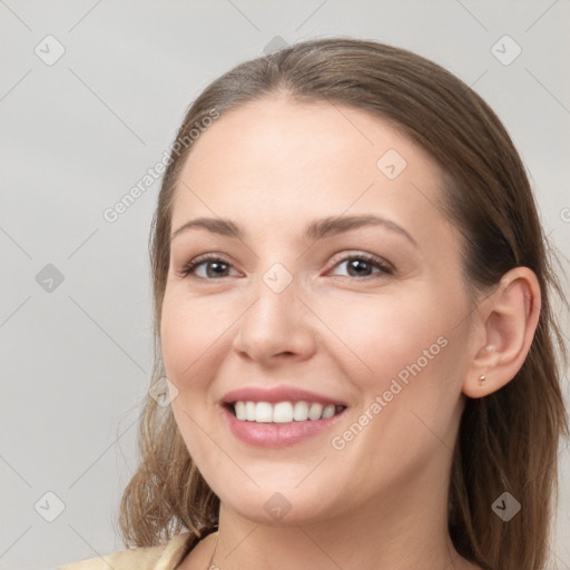 Joyful white young-adult female with long  brown hair and brown eyes