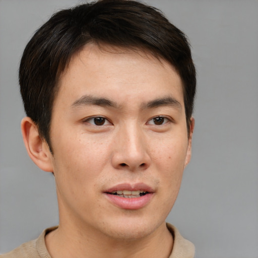 Joyful asian young-adult male with short  brown hair and brown eyes