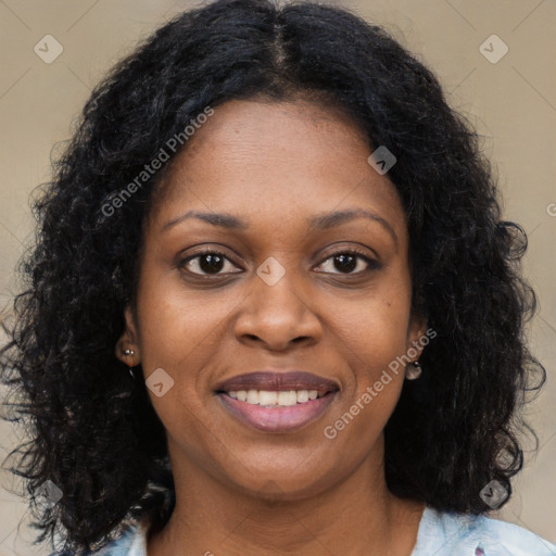 Joyful black young-adult female with long  brown hair and brown eyes