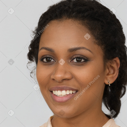 Joyful black young-adult female with long  brown hair and brown eyes