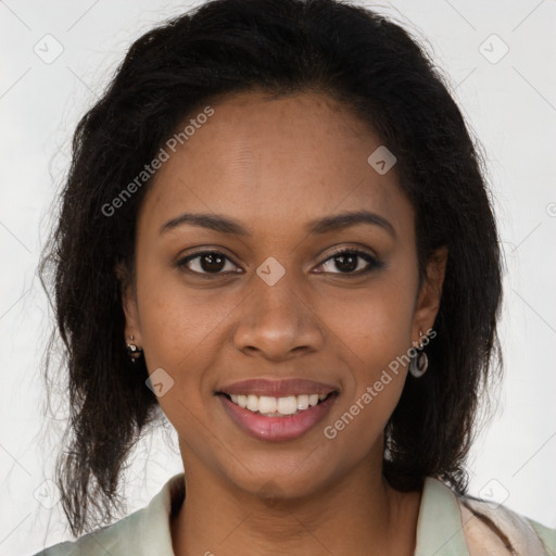 Joyful black young-adult female with long  brown hair and brown eyes