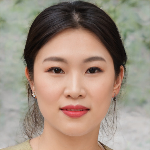 Joyful asian young-adult female with medium  brown hair and brown eyes