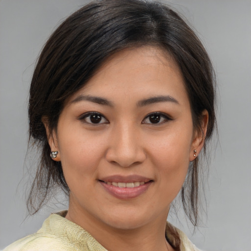Joyful asian young-adult female with medium  brown hair and brown eyes