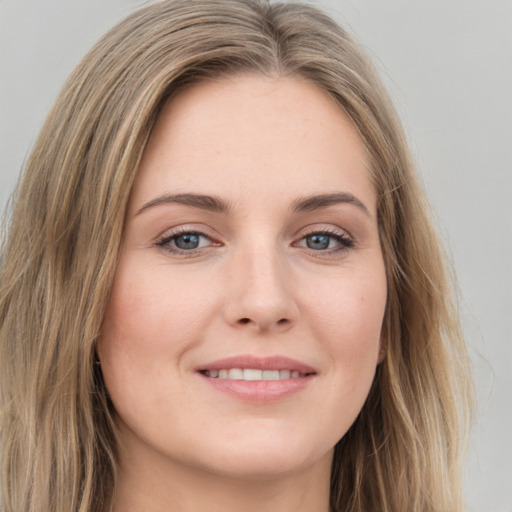 Joyful white young-adult female with long  brown hair and green eyes