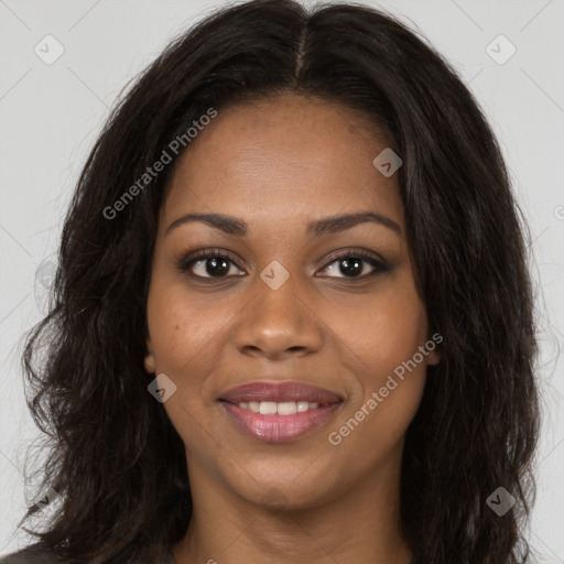 Joyful black young-adult female with long  brown hair and brown eyes