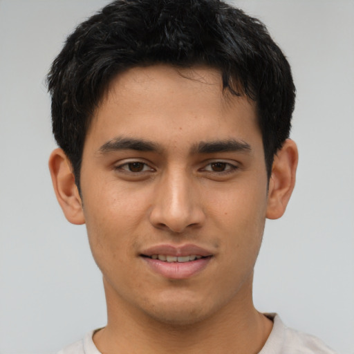 Joyful asian young-adult male with short  brown hair and brown eyes