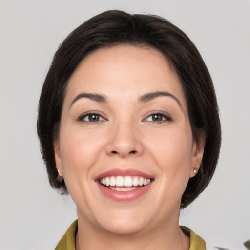 Joyful white young-adult female with medium  brown hair and brown eyes