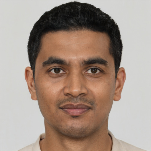 Joyful latino young-adult male with short  black hair and brown eyes