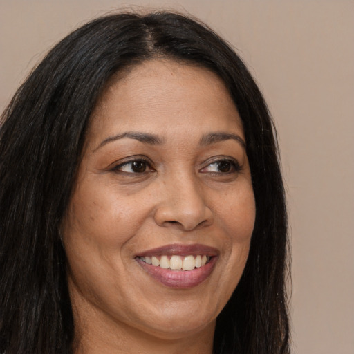 Joyful latino adult female with long  brown hair and brown eyes