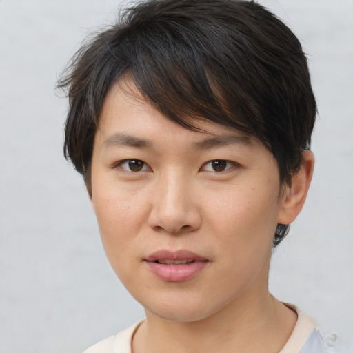 Joyful asian young-adult female with short  brown hair and brown eyes