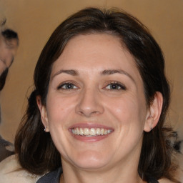 Joyful white adult female with medium  brown hair and brown eyes