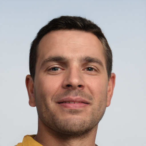 Joyful white young-adult male with short  brown hair and brown eyes