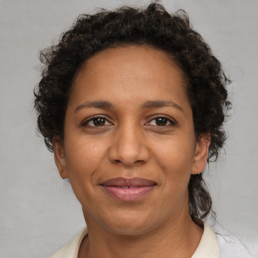 Joyful black adult female with short  brown hair and brown eyes