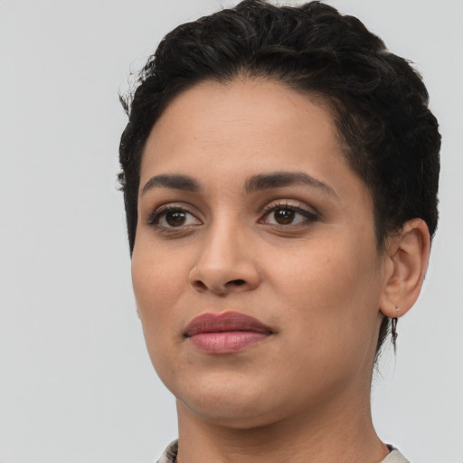 Joyful latino young-adult female with short  black hair and brown eyes