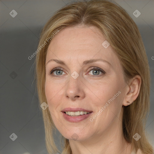 Joyful white adult female with medium  brown hair and grey eyes