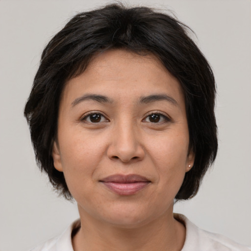 Joyful asian adult female with medium  brown hair and brown eyes