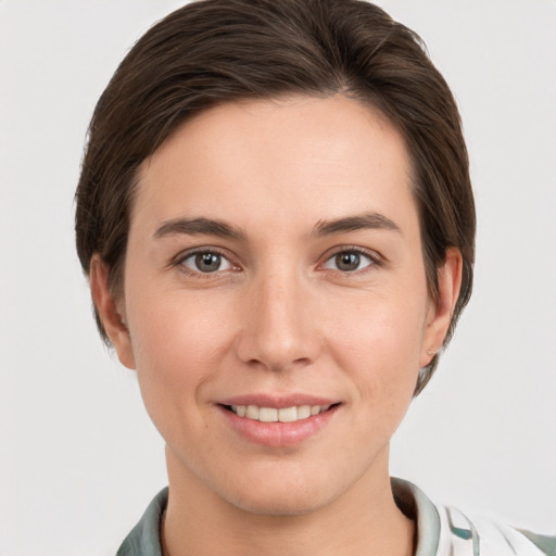 Joyful white young-adult female with short  brown hair and grey eyes