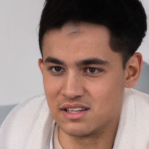 Joyful white young-adult male with short  black hair and brown eyes
