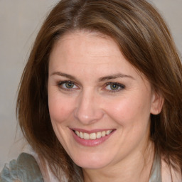 Joyful white adult female with medium  brown hair and brown eyes