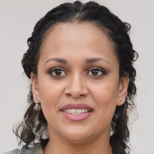 Joyful latino young-adult female with medium  brown hair and brown eyes