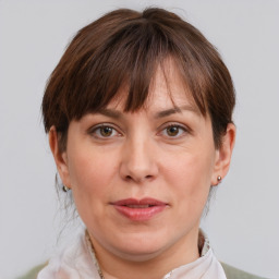 Joyful white adult female with short  brown hair and grey eyes