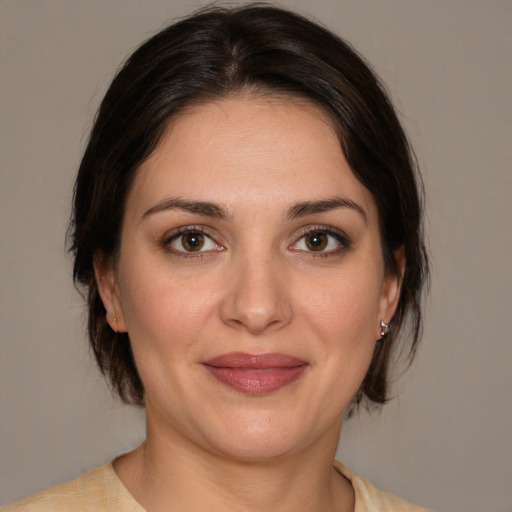 Joyful white young-adult female with medium  brown hair and brown eyes