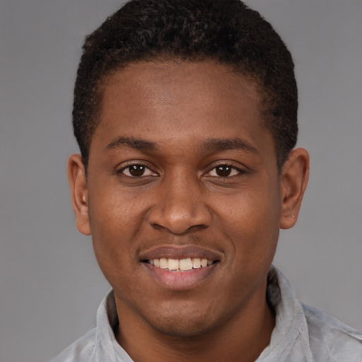 Joyful latino young-adult male with short  brown hair and brown eyes