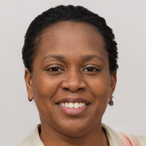 Joyful black adult female with short  brown hair and brown eyes
