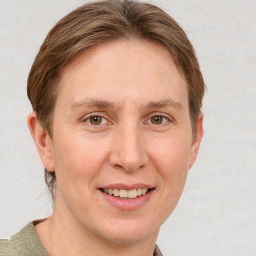 Joyful white adult female with short  brown hair and grey eyes