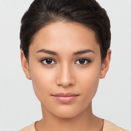 Joyful latino young-adult female with short  brown hair and brown eyes