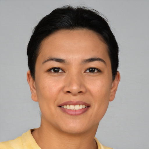 Joyful asian young-adult female with short  black hair and brown eyes
