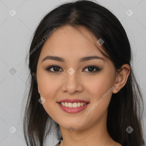 Joyful asian young-adult female with long  brown hair and brown eyes