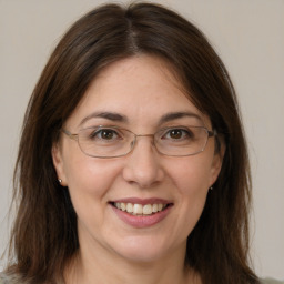 Joyful white adult female with medium  brown hair and grey eyes