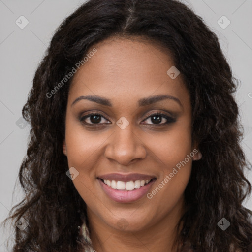 Joyful black young-adult female with long  brown hair and brown eyes