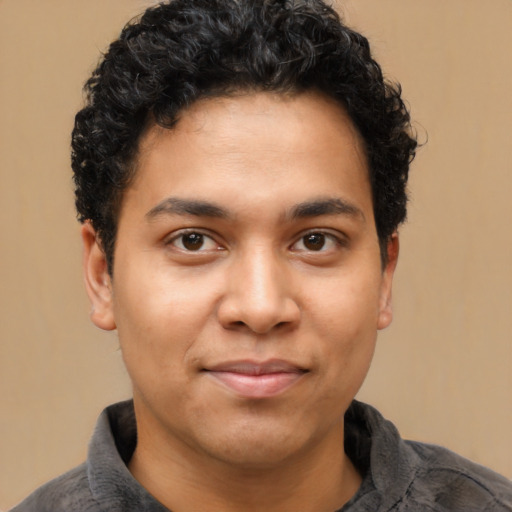 Joyful latino young-adult male with short  brown hair and brown eyes